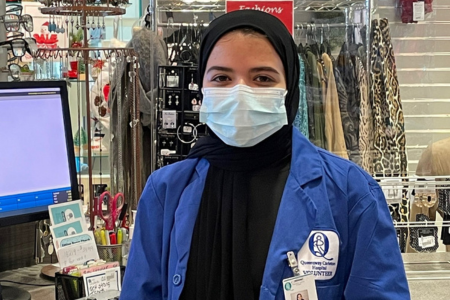 Volunteer serving member of community while smiling